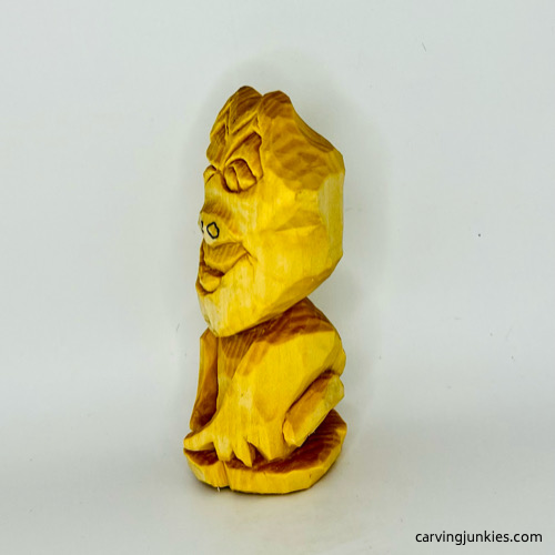 Left view of unpainted wooden frog carving