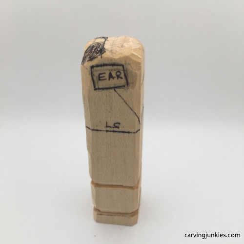 Right view of ear on female wood carving