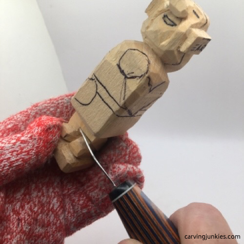 Carving legs on female wood carving