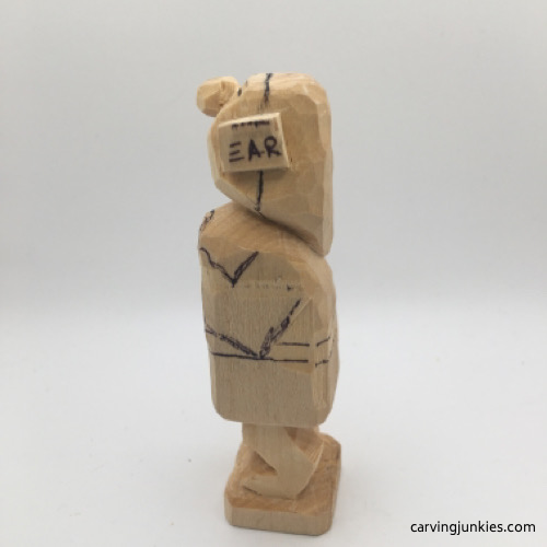 Left view of boots on female wood carving