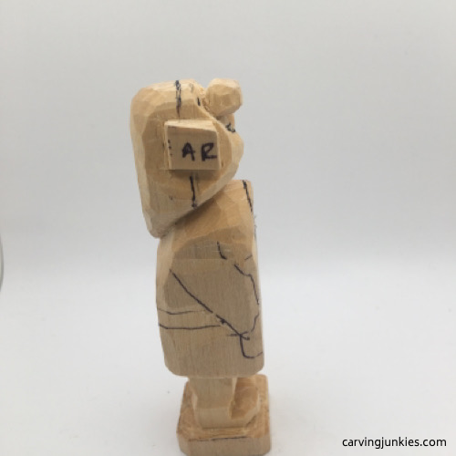 Right view of boots on female wood carving