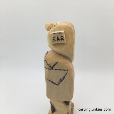 Left leg marked on female wood carving