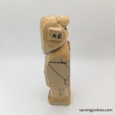 Right view of straight leg on female wood carving