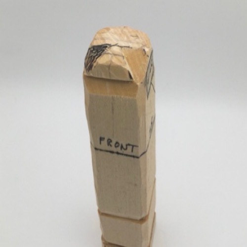 Completed pyramid cut on female wood carving