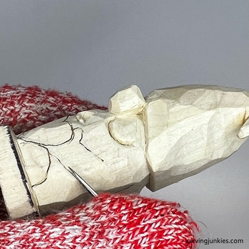 Separating arm on gnome carving