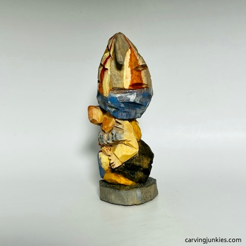 Left side of painted gnome carving