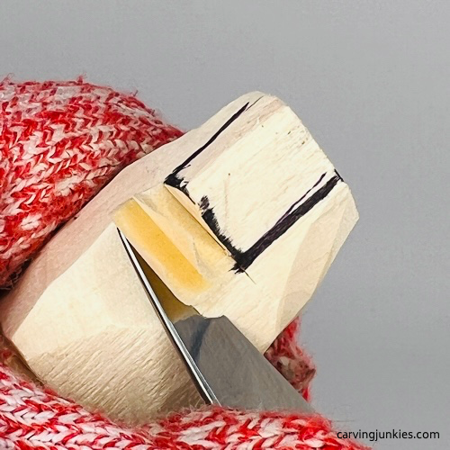 Cutting curved hat on gnome carving