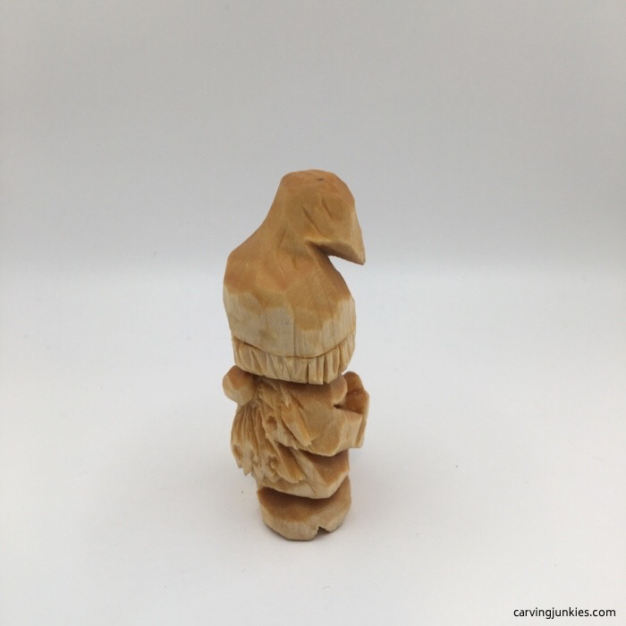 Left side view of carved gnome before painting