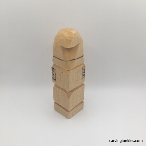 Making tassel cut on back of wooden gnome