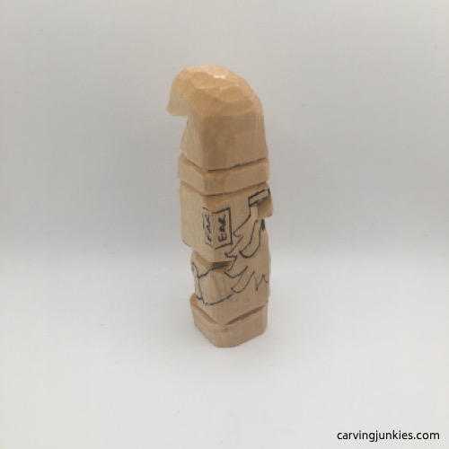 Carving clasped arms on wooden gnome