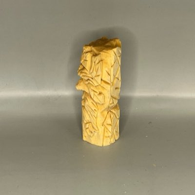 Left view of unpainted wooden green man