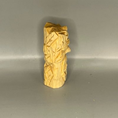 Right view of unpainted wooden green man