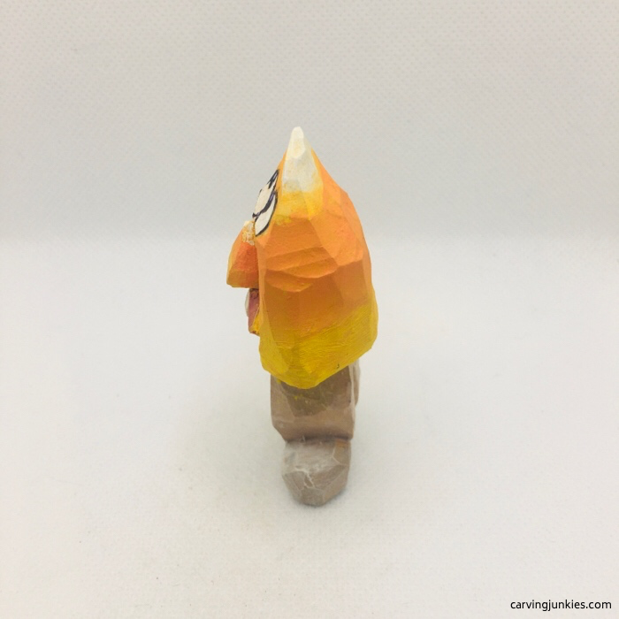 Left view of painted Halloween candy corn carving