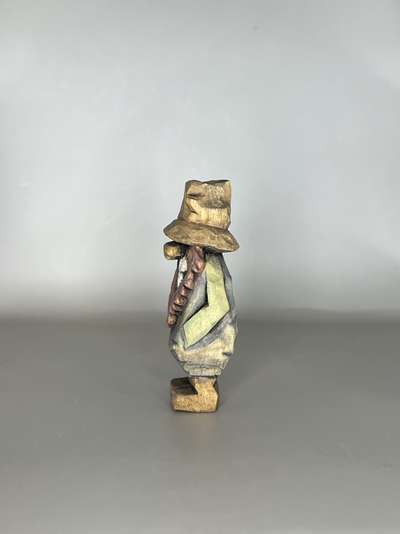 Left view of painted hillbilly carving