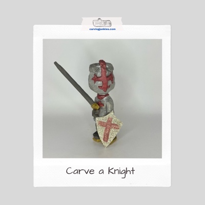 Silver and red knight wood carving with a shield and sword