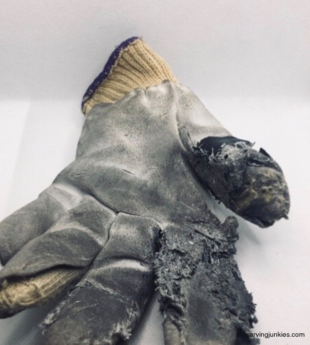 Dirty wood carving glove Worn leather-lined Kevlar glove