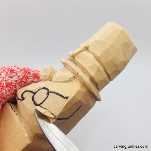 Carving arms on leprechaun wood carving