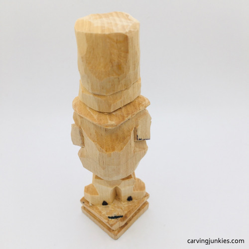 Cutting shoes on leprechaun wood carving