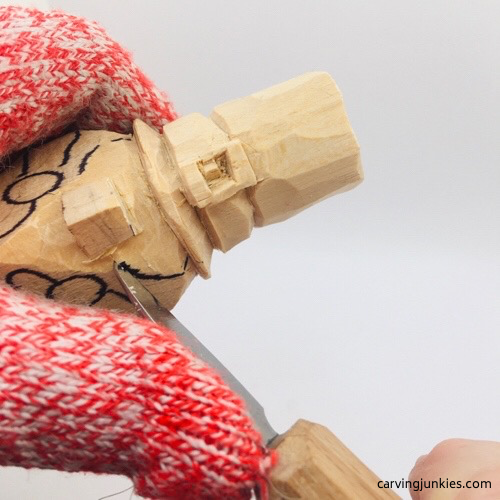 Carving cheeks on leprechaun wood carving