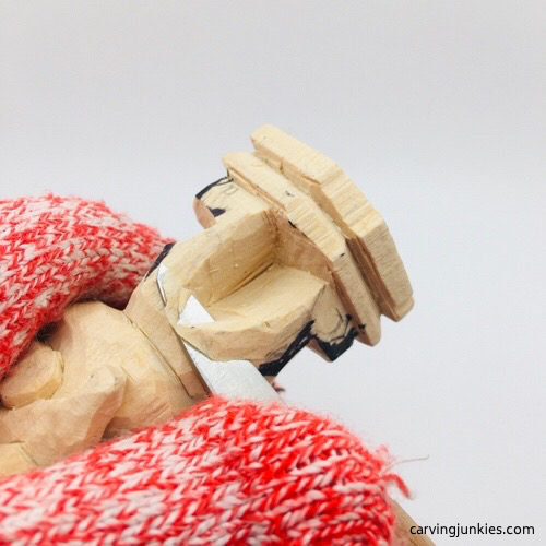 Shaping legs on leprechaun wood carving