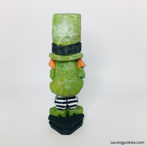 Back view of painted leprechaun wood carving