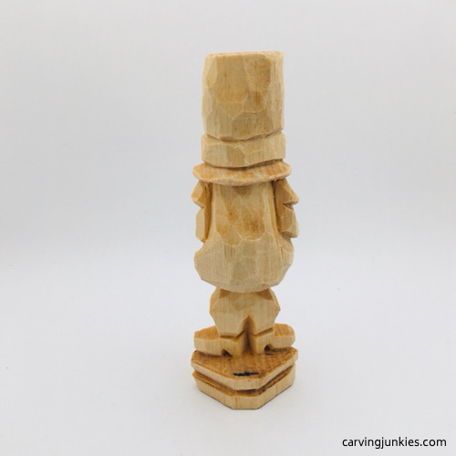 Back view of unfinished wood carved leprechaun