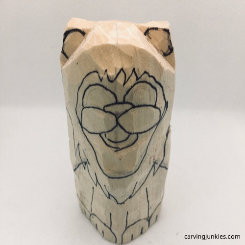 Adding guidelines to lion woodcarving