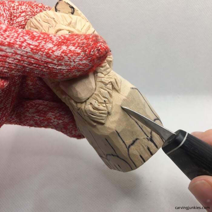 Cutting the legs on lion wood carving