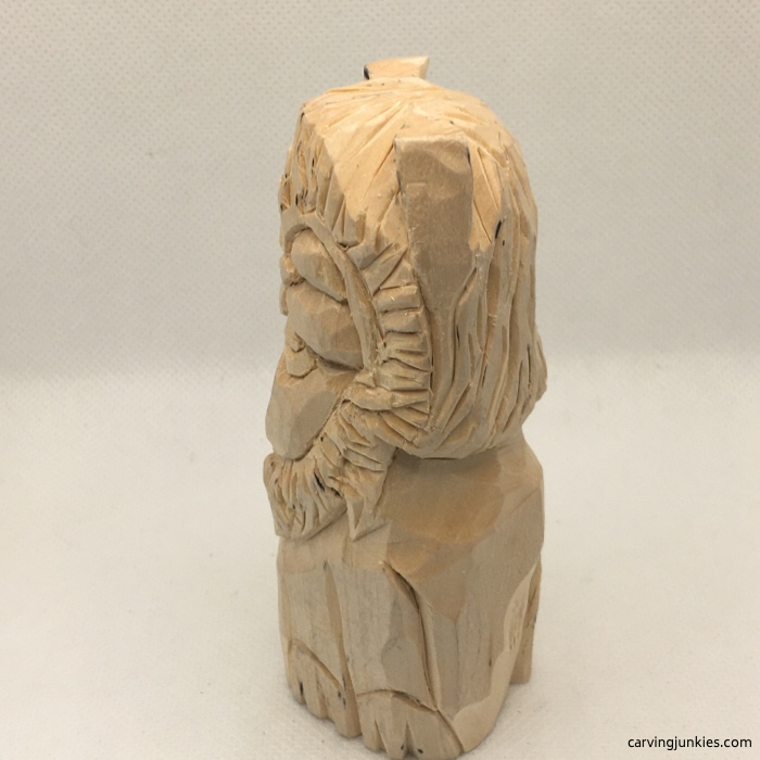 Side view of lion wood carving progress