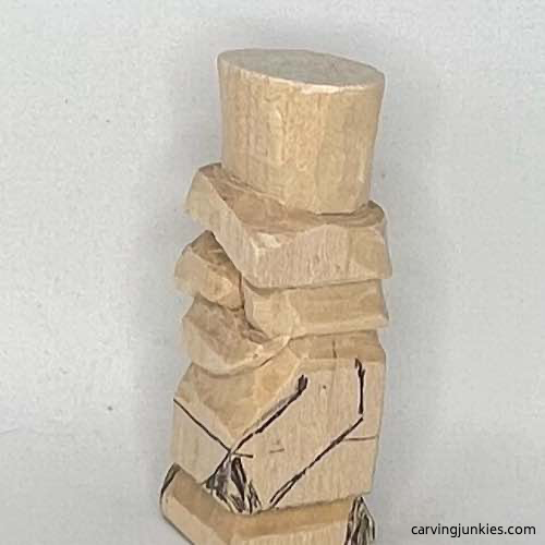 Left arm is drawn on little wood carving