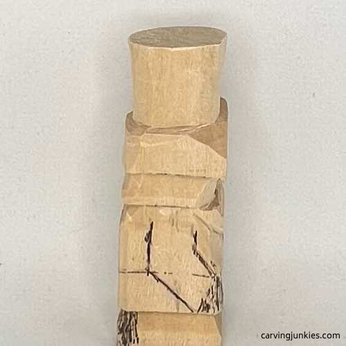 Right arm on little wood carving