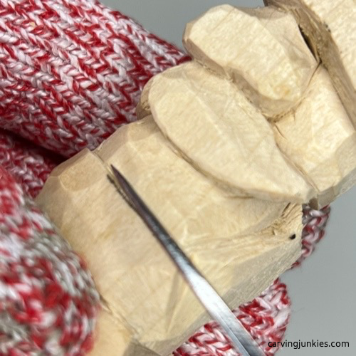 Carving the waist of little wood carving