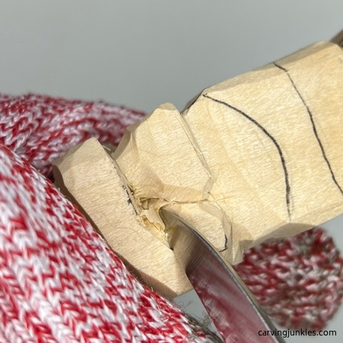 Carving eyes on little wood carving