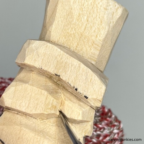 Shaping nose on little wood carving