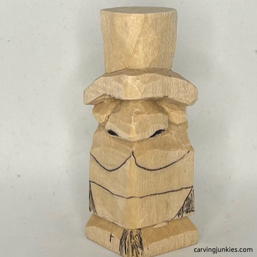 Nostrils are sketched on little wood carving