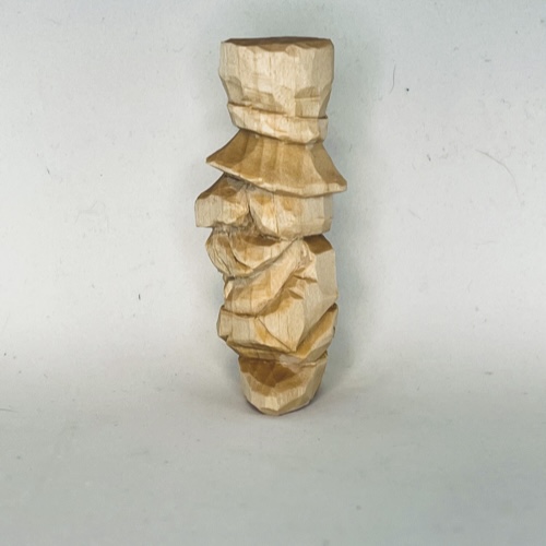 Left side of unpainted little wood carving