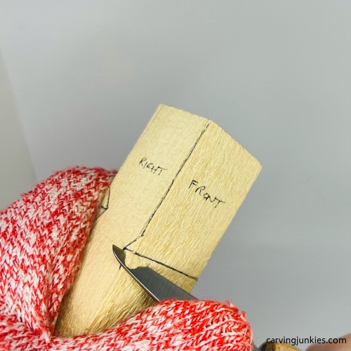 Notching corners of little man caricature carving