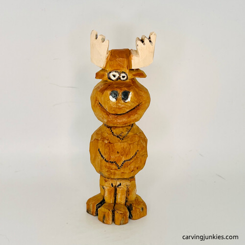 Front side of painted moose wood carving Front view of painted moose wood carving