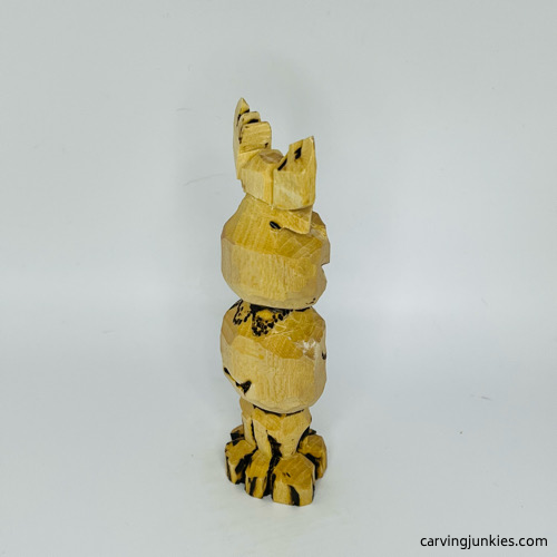 Front view of wood burned on moose carving Right side of wood burned on moose carving
