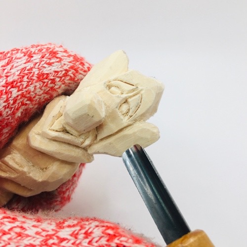 Carving inner ear on mouse wood carving