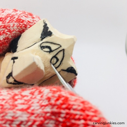 Carving eyes on mouse wood carving