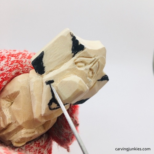 Carving lips on mouse wood carving