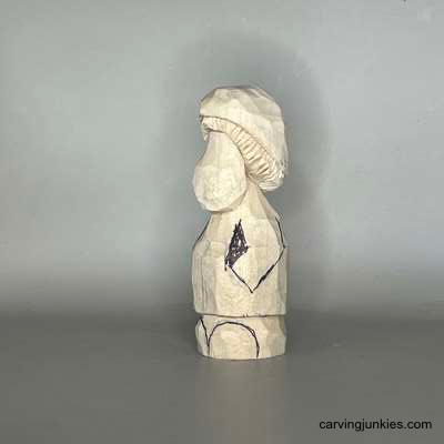 Carve a tiny forest dweller with a big personality Left view of sketched arms on wood mushroom monster