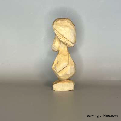 This mushroom carving brings maximum whimsy Left view of unpainted mushroom monster wood carving