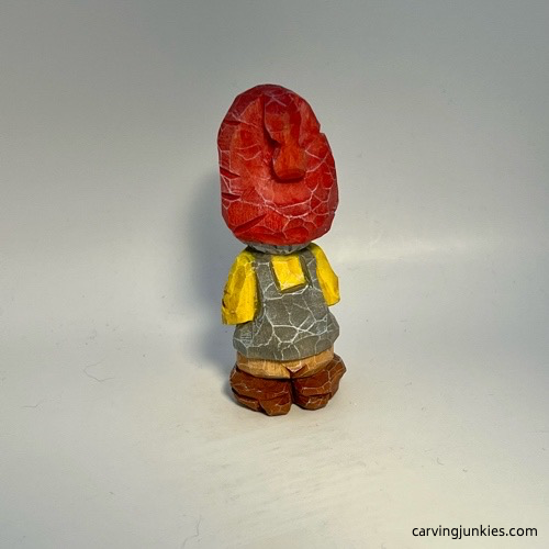 Back view of painted nisse wood carving