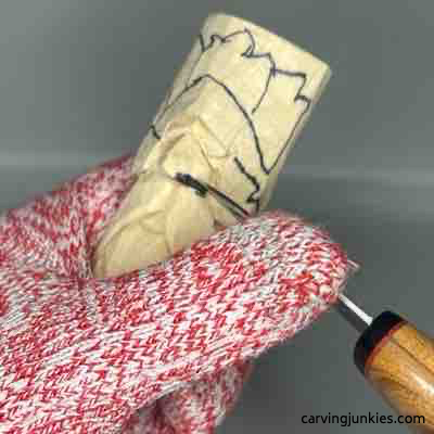 Carving nostril on wooden green man