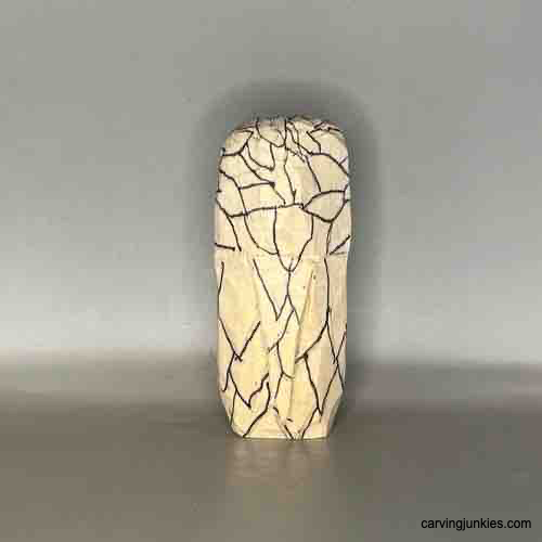 Learn to shape wood into an owl with our step-by-step tutorial. Back view of sketched feathers on owl carving