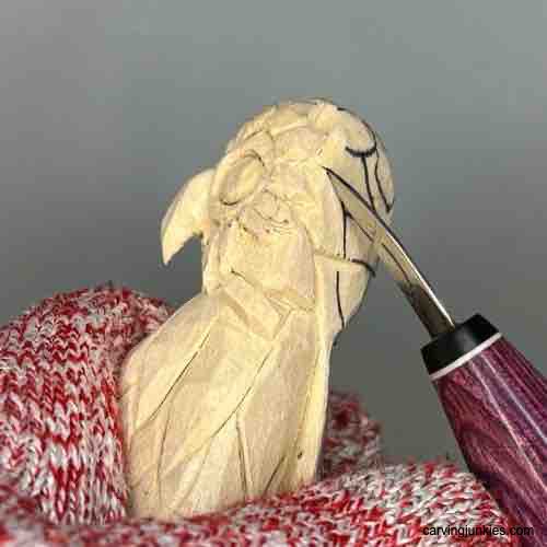 Learn to make a wooden owl with our clear, detailed guide. Shaping back feathers on owl carving