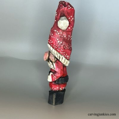 Left view of painted wood carved Christmas gnome