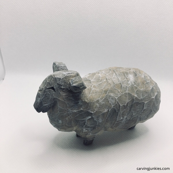 Left view of painted sheep carving